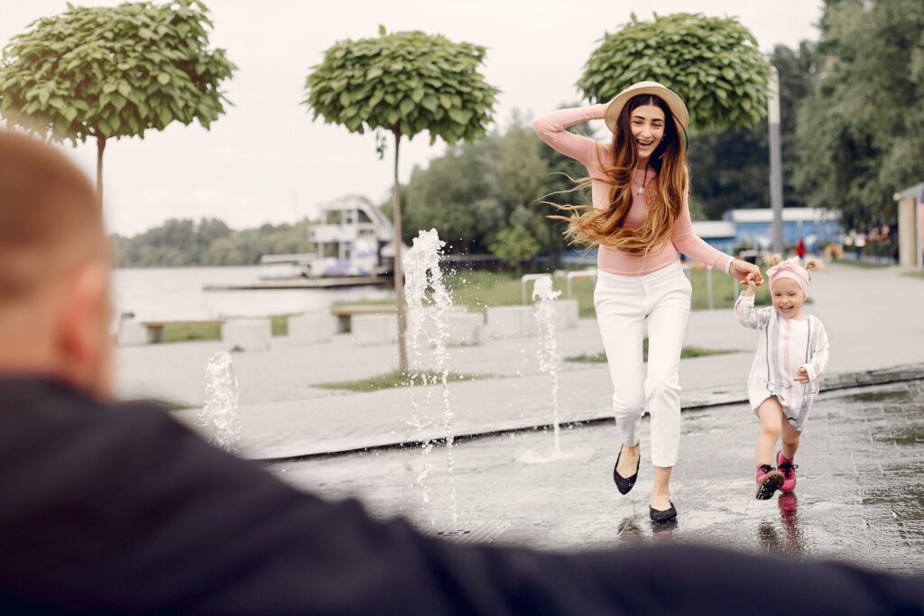family with daughter playing park