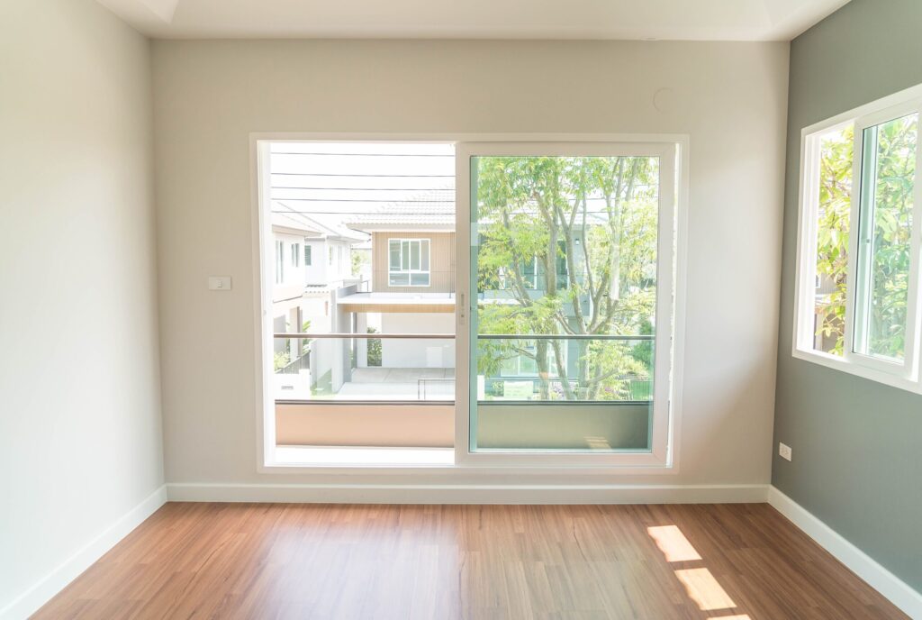 Natural light streaming through large glass doors in a bright, well-lit rental property