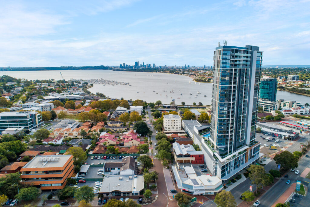 Aerial view of Applecross Perth showing modern high-rise apartments, Swan River, marina and city skyline in the distance.