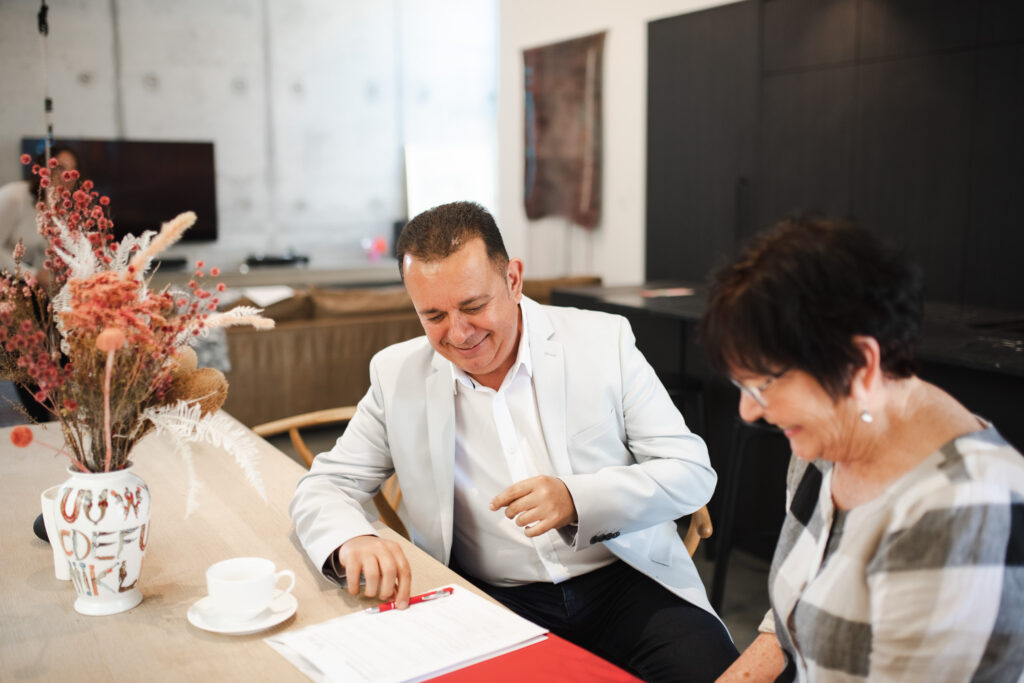 Semple Property Group agent meeting with an older client at home, discussing downsizing and retirement property options in Perth