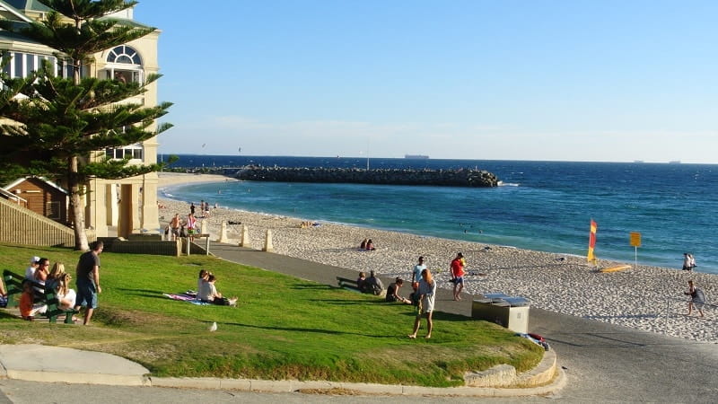 Cottesloe Beach in Perth with grassy foreshore, swimmers and Indian Ocean views, Western Australia.