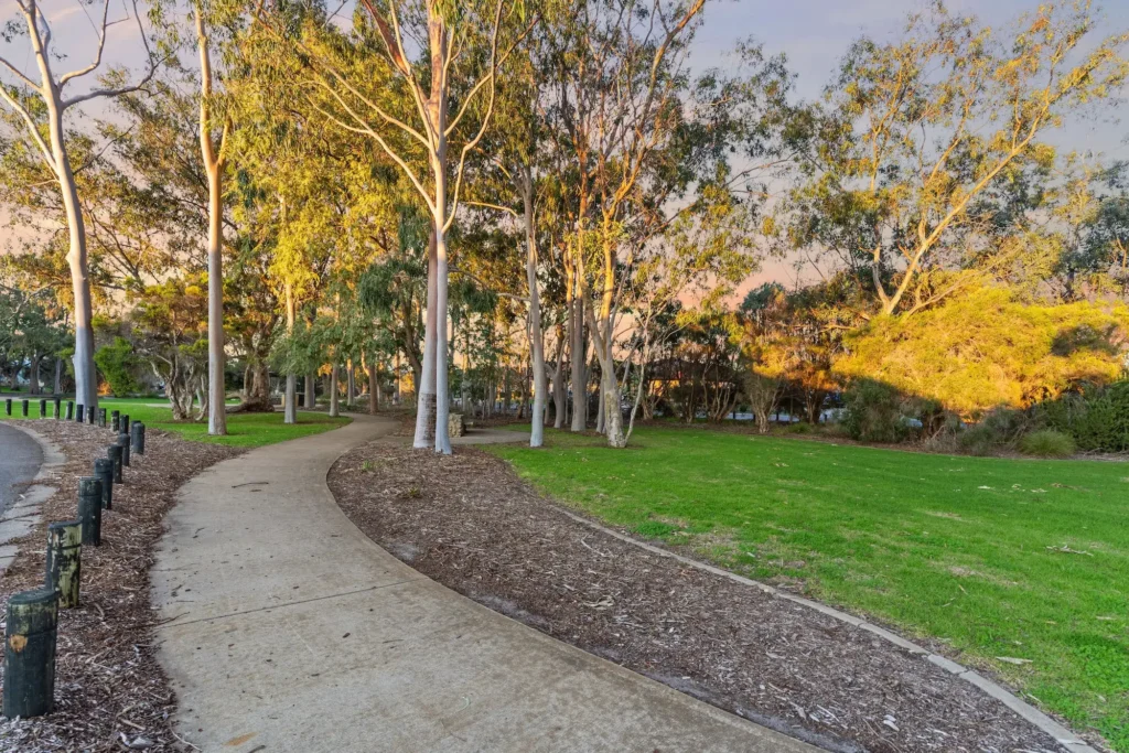 Walking trail and parkland in Harrisdale, Perth WA, featuring green open spaces, mature trees and family-friendly outdoor recreation areas.