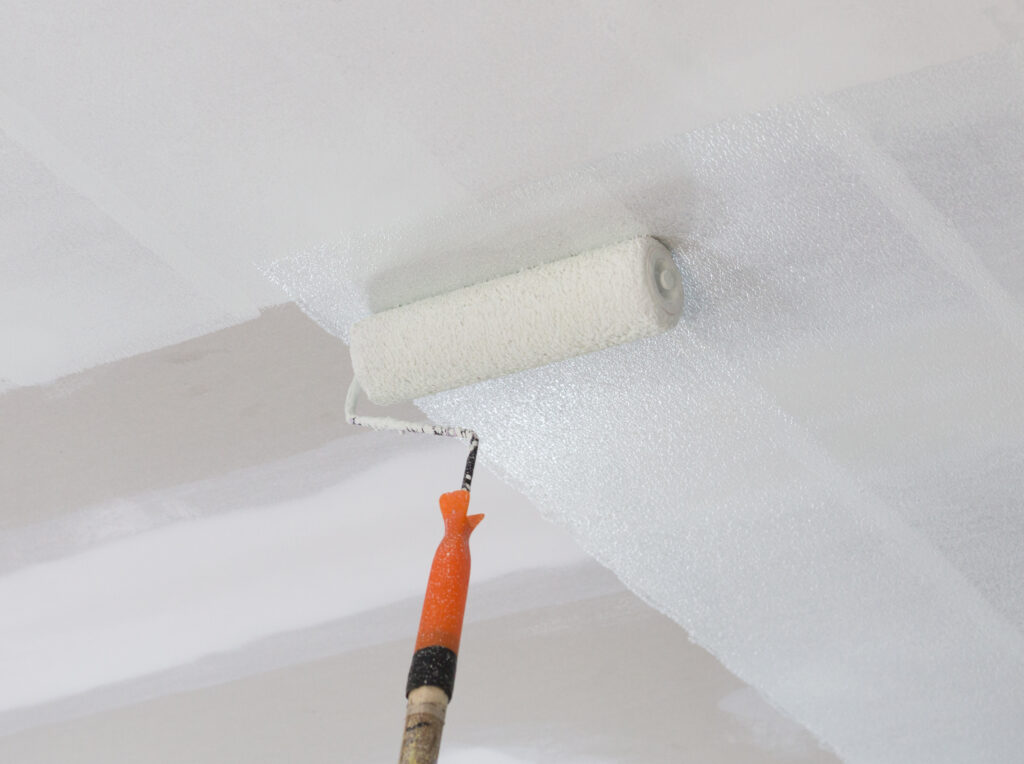Fresh white paint being applied to a rental property ceiling, highlighting smart property improvements that increase rental appeal and rental yield